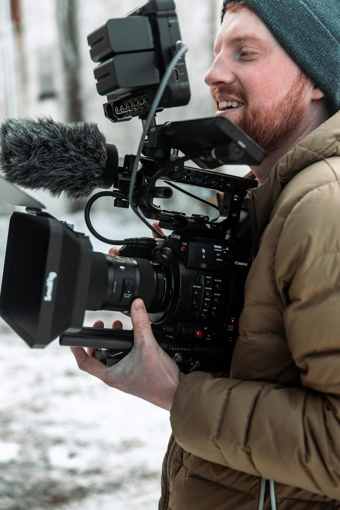 Finnish male camera operator holding a professional broadcast camera