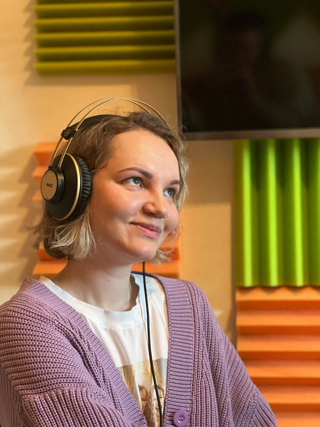 Finnish female television news anchor smiling in a studio