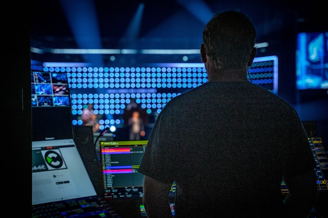 Broadcast engineer monitoring live signal feeds on multiple screens