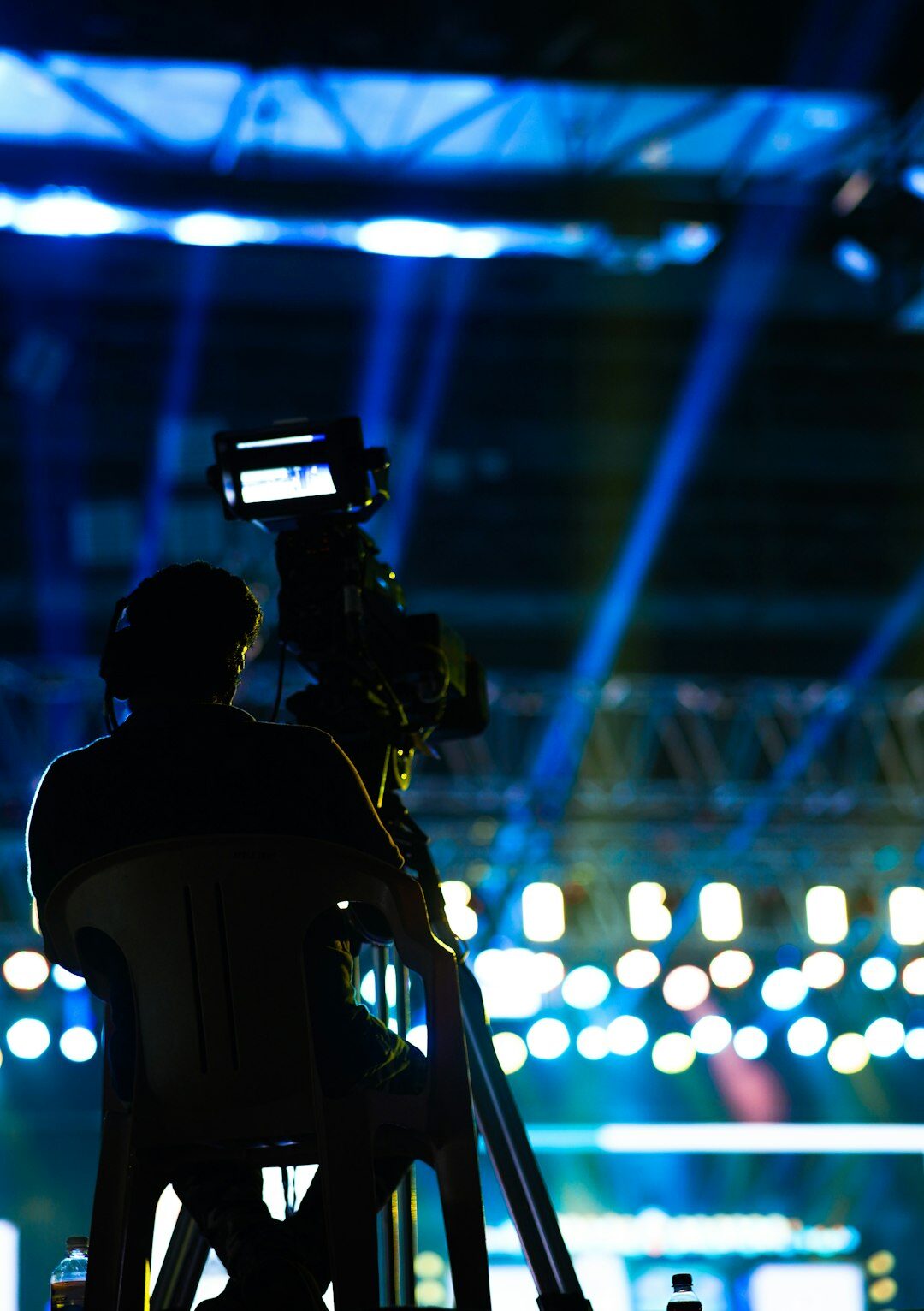 Camera operator filming a live television broadcast at an event